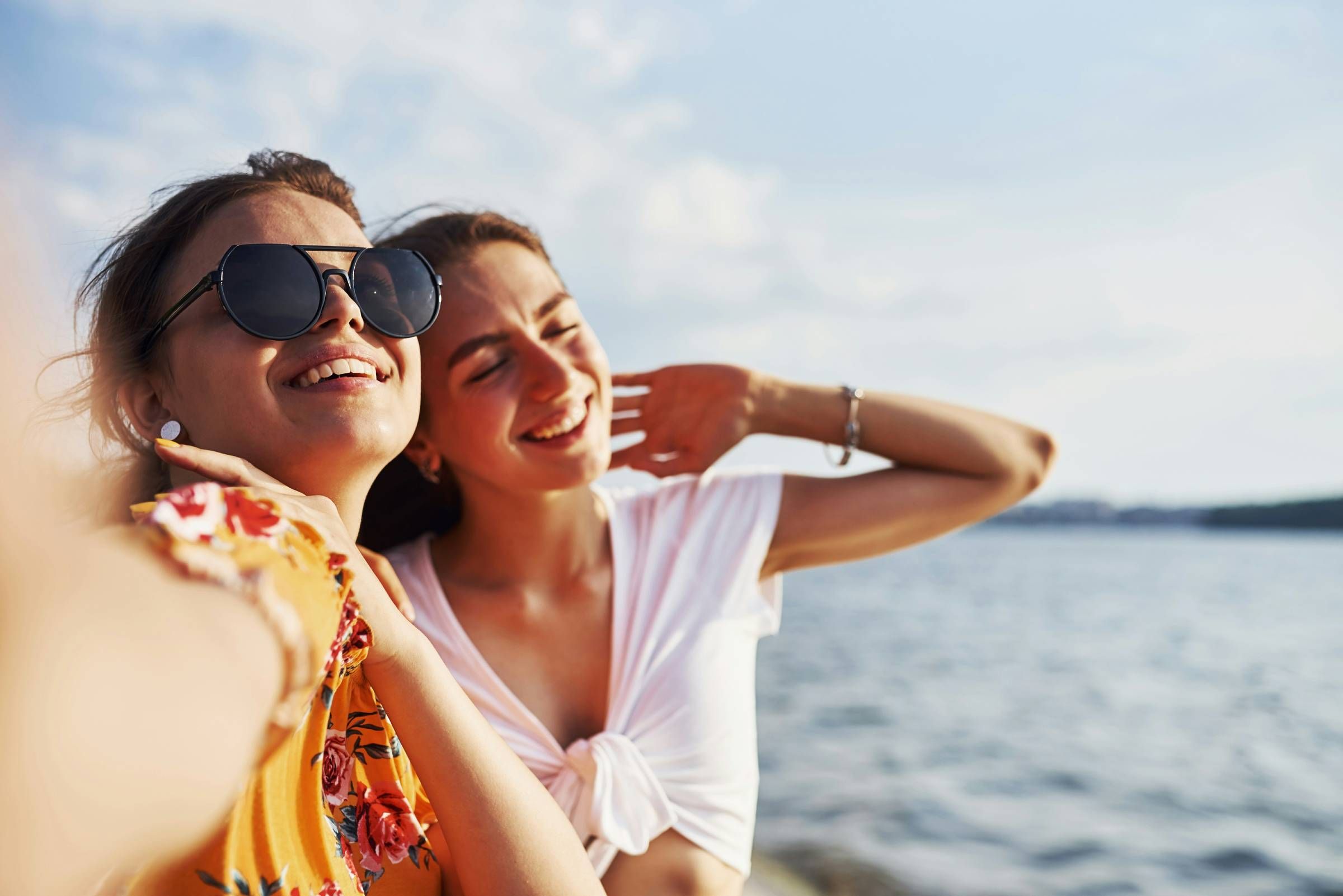 Evolve Grove Park A woman in a red swimsuit gracefully floats on the surface of a clear blue pool, enjoying a moment of relaxation.